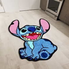 a cartoon character rug on the floor in a kitchen