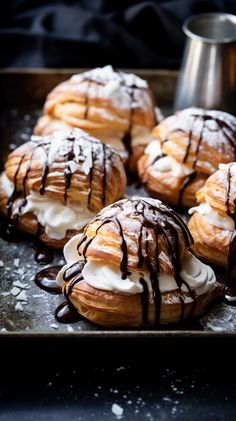 several pastries with chocolate drizzled on them