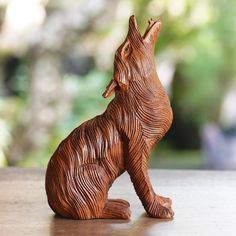 a wooden carved animal sitting on top of a table