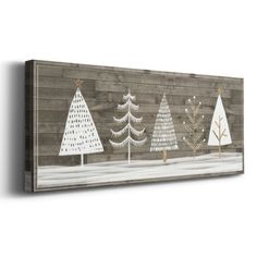 three white christmas trees on a wooden wall