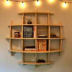 a shelf with several books and lights on it