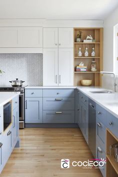 a kitchen with blue cabinets and white counter tops