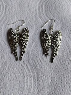 I used a silver colored angel wing pendant with a silver colored earring hooks Silver Winged Sterling Silver Earrings, Winged Sterling Silver Earrings In Silver, Silver Sterling Silver Winged Earrings, Silver Angel Wings Elegant Earrings, Elegant Silver Angel Wings Earrings, Silver Wing-shaped Earrings, Nickel-free Silver Winged Jewelry, Angel Wing Earrings, Angel Wing Pendant