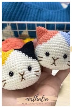 two small stuffed animals are sitting on someone's hand in front of a basket