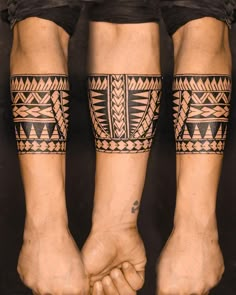 two people holding hands with tattoos on their arms and legs, both wearing black shorts