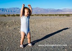 a small child standing in the middle of a desert