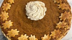 a close up of a pie with icing on it and stars around the crust