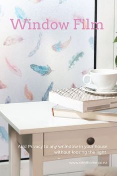 a white table topped with a cup and saucer