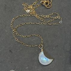 A gorgeous carved and faceted rainbow moonstone crescent moon is wired onto your choice of 14k gold filled, sterling silver, or 14k rose gold chain. This style is so current and pretty. Coordinating earrings are available. This listing is for the necklace only. Please choose your necklace length or the standard 18" will be sent. The default is the metal shown if you do not choose a metal. Your jewelry will arrive beautifully giftboxed. Gold Crescent Wire Wrapped Necklaces, Gold Moon-shaped Wire Wrapped Jewelry, Gold Crescent Wire Wrapped Jewelry, Crescent Moonstone Necklace In Gold, Gold Crescent Moonstone Necklace, Moonstone Dangle Jewelry With Moon Charm, Delicate 14k Gold-filled Jewelry With Moon Charm, Dainty Wire Wrapped Moonstone Jewelry, Dainty 14k Gold Filled Moon-shaped Jewelry