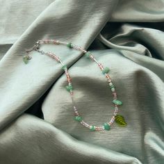 Leaflet is a handmade adjustable beaded necklace made with pink, clear, and sage green glass seed beads. It includes a green glass leaf pendant and light aventurine stones. <3 ALSO SEE: https://www.etsy.com/listing/1301138023/woodland-mushroom-brown-mushroomgreen Green Dainty Crystal Necklaces For Jewelry Making, Adjustable Green Beaded Necklace With Heart Beads, Dainty Adjustable Green Crystal Necklaces, Green Crystal Necklaces With Colorful Beads For Healing, Dainty Adjustable Green Crystal Necklace, Green Beaded Crystal Necklace For Healing, Dainty Handmade Green Crystal Necklace, Dainty Green Adjustable Crystal Necklace, Adjustable Green Beaded Necklace With Nature-inspired Style