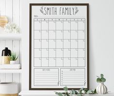 a family calendar hanging on the wall above a fireplace