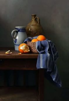 an orange sits on a table next to a pitcher