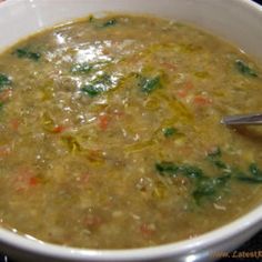 a white bowl filled with soup on top of a table