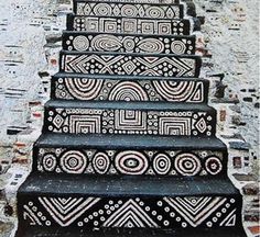 an artistic stair case painted with black and white designs