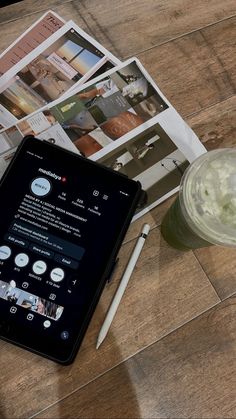 a tablet computer sitting on top of a wooden table next to a cup of coffee