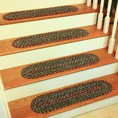 carpeted stair treads on the rise of a set of stairs