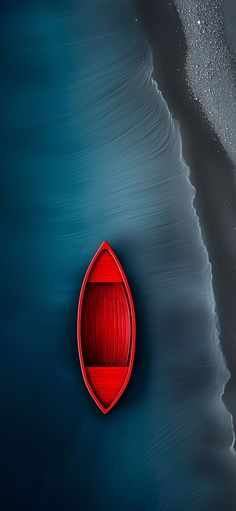 a red boat floating on top of a body of water