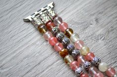 "This lovely beaded iwatch band is made from genuine Cherry Quartz stone and silver plated findings. Beads are 8mm round and total weight is 56 gram for 5\" long band. You can personalize your band by adding up to 8 letters to it. Letter beads are silver plated and double-sided. The watch band fits all iwatch as long as you select the right iwatch size (38mm, 40mm, 42mm or 44mm). There are no clasps, the cord can stretch. Measure your wrist tightly and select your SIZE from the drop-down menu. T Silver Adjustable Apple Watch Band With Round Beads, Adjustable Silver Beaded Apple Watch Band, Silver Adjustable Bohemian Apple Watch Band, Bohemian Adjustable Silver Apple Watch Band, Bohemian Silver Adjustable Apple Watch Band, Silver Beaded Bracelets With Round Beads, Bohemian Silver Watch Bands With Bracelet Strap, Bohemian Silver Bracelet Strap Watch Bands, Bohemian Silver Watch Band As Gift