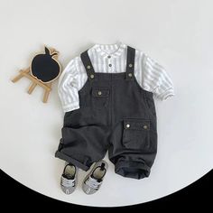 Get your little one ready for autumn adventures with our Kids Cool Solid Overalls! 🍁 Perfect for children aged 1-6 years, these unisex overalls are crafted from soft, high-quality cotton, ensuring both comfort and durability. The solid pattern and cool style make them a versatile addition to any wardrobe. Featuring a loose fit and an elastic waist closure, these overalls provide a snug, true-to-size fit that allows for easy movement and play. Ideal for both boys and girls, they are perfect for any casual outing, from playdates to family gatherings. Keep your child stylish and comfortable this autumn with these must-have overalls! ✨🌼 Specifications: Material: Cotton Style: Cool Pattern Type: Solid Season: Autumn Gender: Unisex Age Range: 1-6 years Closure Type: Elastic Waist Department Na Casual Striped Shirt, Vertical Striped Shirt, Striped Shirts, Kids Blouse, Casual Tunics, Korean Casual, Romper Outfit, Girls Blouse, Striped Long Sleeve Shirt