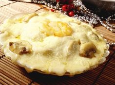 a pie sitting on top of a wooden table next to a silver ball chain necklace