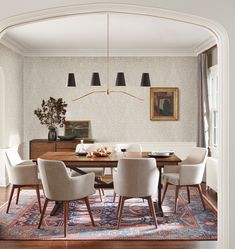 a dining room table with chairs and a chandelier