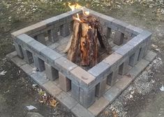 a fire pit made out of cinder blocks with flames coming from it's sides