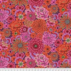 an orange and pink floral print fabric with large flowers on the bottom, in various colors