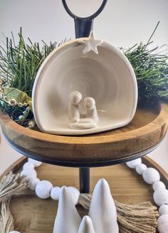 three tiered tray with two white ceramic figurines