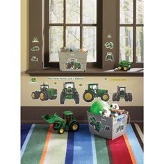 a child's room with tractor decals on the wall and toys in front of it