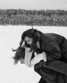 a woman in the snow with her hands on her face