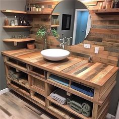 a bathroom with a sink, mirror and shelves