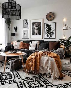 a black and white living room with pictures on the wall, couches, rugs and coffee table