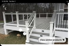 a white deck with stairs and railings