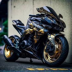 a black and gold motorcycle parked next to a building