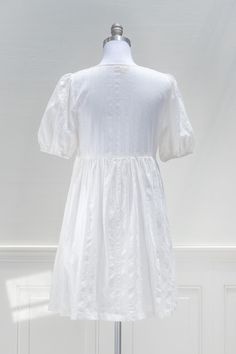 A breezy little white dress made for sunny summer days, the Room with a View Dress features delicately patterned cotton, side-seam pockets, an empire waistline, short puffed sleeves, and a button-front closure. . Details: S: Bust: 36", Empire Waist: 32", Length: 33" M: Bust 38", Empire Waist: 34", Length: 34" L: Bust 40", Empire Waist: 36", Length: 35" Length Measured from Shoulder Length Waist to Hem: 22" Lined, Unlined Back of Bodice Material: 100% Cotton Gentle Wash Cold / Hang Dry Imported S Cotton A-line Sundress For Daywear, Knee-length Sundress With Smocked Bodice For Daywear, Spring Daywear Peasant Dress With Puff Sleeves, Spring Peasant Dress With Puff Sleeves For Daywear, Spring Puff Sleeve Peasant Dress For Daywear, Spring A-line Short Sleeve Dress For Daywear, Cotton Midi Dress With Short Sleeves For Daytime, Puff Sleeve Broderie Anglaise Dress For Daywear, Casual Broderie Anglaise Puff Sleeve Dress