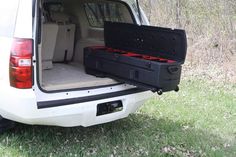 the back end of a white van with its trunk open