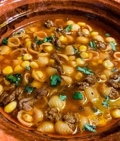 a bowl filled with pasta and meat soup