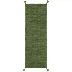 a green rug with tassels on the bottom and one fringe at the end