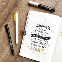 a notebook with some writing on it next to two markers and a marker pen that says, happiness can be found in the darkest times of one day