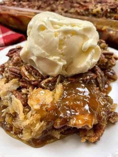 a close up of a plate of food with ice cream on top and another dish in the background