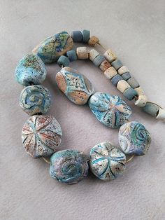 a necklace made out of ceramic beads on a white surface