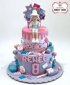 a pink and blue birthday cake with the number eight on it's top tier