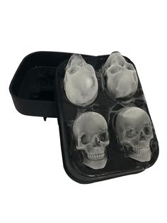 an ice tray with four skulls in it