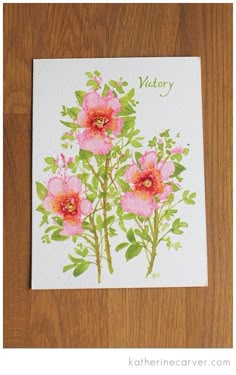 a card with pink flowers and green leaves