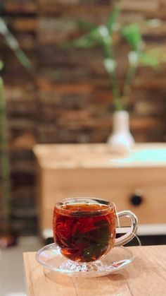 a cup of tea sitting on top of a wooden table