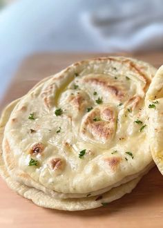 two pita breads are sitting on a cutting board