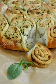 a close up of a pastry on a table with some green leafy leaves around it