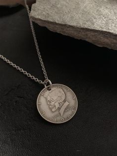 This is a real 1964 silver half dollar that has been carved for an artistic aesthetic.  This pendant is suitable for either guys or gals and comes with an extremely strong, high quality surgical stainless steel closed link chain.  All jewelry from my studio will arrive attractively packaged and ready for gifting or keeps. READY TO SHIP! MEASUREMENTS & SPECIFICS:PENDANT: 3cm round METAL: coin silver FINISH: oxidized / slightly blackenedCHAIN: 20" 2mm high quality surgical stainless steel w/ l Aesthetic Pendants Men, Coin Necklace Outfit, Hobo Nickel, Carved Skull, Necklace Outfit, Artistic Aesthetic, Artist Supplies, Skull Carving, Jewelry For Men