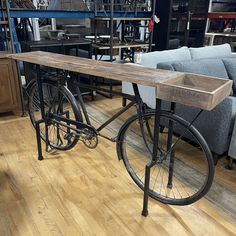 a bike is parked next to a couch in a room with wooden floors and furniture