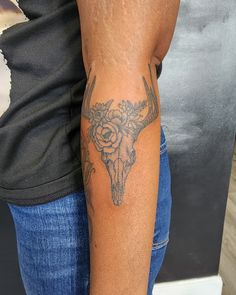 a person with a tattoo on their arm and the other arm has a bull's head